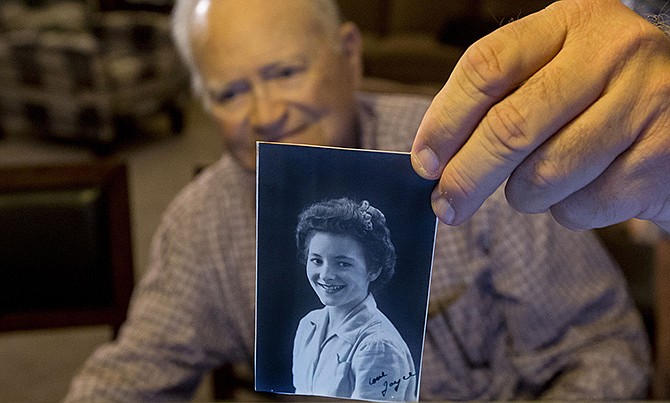 Norwood Thomas, holds up a photo of Joyce Morris at his home Nov. 16 in Virginia Beach, Virginia. Thomas is embarking on a 10,500-mile journey to Australia to visit Morris. She was the 93-year-old World War II veteran's wartime girlfriend.