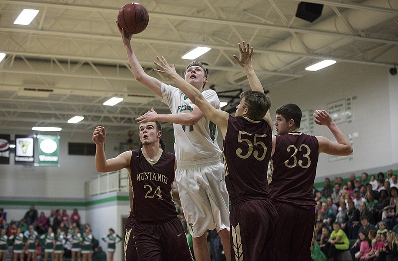 Tim Fick of Blair Oaks puts up a shot among three Eldon defenders during Tuesday night's game in Wardsville.