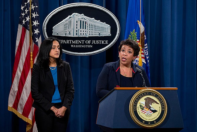 Attorney General Loretta Lynch, joined by Principal Deputy Assistant Attorney General Vanita Gupta speaks during a news conference at the Justice Department in Washington, Wednesday, Feb. 10, 2016, about Ferguson, Missouri. The federal government sued Ferguson on Wednesday, one day after the city council voted to revise an agreement aimed at improving the way police and courts treat poor people and minorities in the St. Louis suburb. 