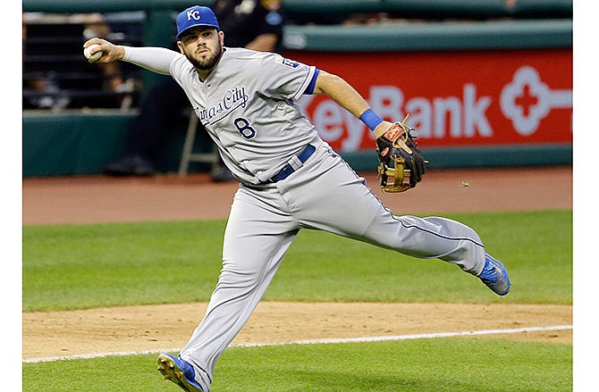 In this Tuesday, July 28, 2015 file photo, Kansas City Royals' Mike Moustakas fields a ball during a baseball game in Cleveland. The Royals and third baseman Mike Moustakas have agreed to a $14.3 million, two-year contract that not only avoids arbitration this year but also next year, Thursday, Feb. 11, 2016. 