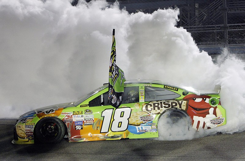 Kyle Busch does a burnout after winning the Sprint Cup Series race and the season title on Nov. 22, 2015, at Homestead-Miami Speedway in Homestead, Fla. 