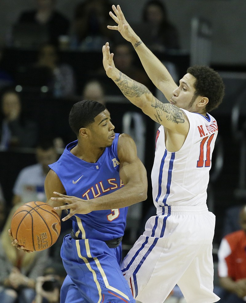 Tulsa guard Shaquille Harrison (3) looks to pass against SMU guard Nic Moore (11) during the first half of an NCAA college basketball game Wednesday, Feb. 10, 2016, in Dallas.