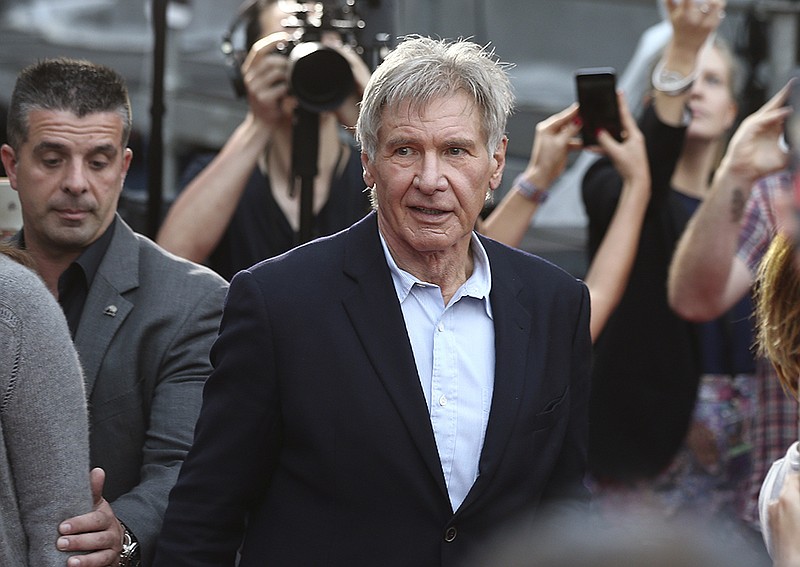 In this December 10, 2015 file photo Harrison Ford walks during a Star Wars fan event in Sydney. Ford is in Australia to promote his latest film "Star Wars: The Force Awakens". British health authorities said on Thursday Feb. 11, 2016 that criminal charges have been laid against producers of "Star Wars: The Force Awakens" over an on-set accident in which Harrison Ford broke his leg. 