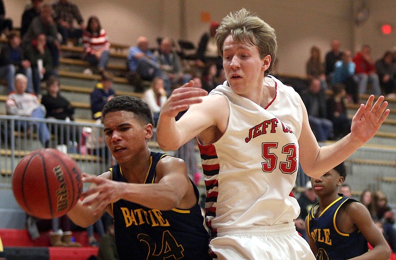 Tim Nahach of Jefferson City and Alexander Smith of Battle fight for control of the ball during Friday night's game at Fleming Fieldhouse.