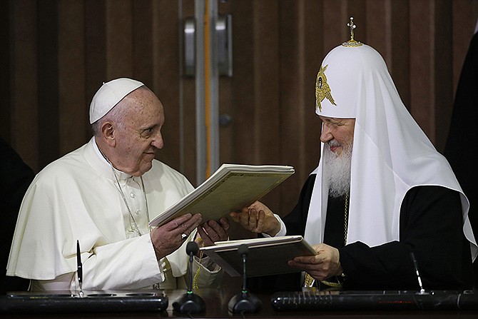 Pope Francis, left, and Russian Orthodox Patriarch Kirill exchange a joint declaration on religious unity Friday at the Jose Marti International airport in Havana, Cuba. The two religious leaders met for the first-ever papal meeting, a historic development in the 1,000-year schism within Christianity. 