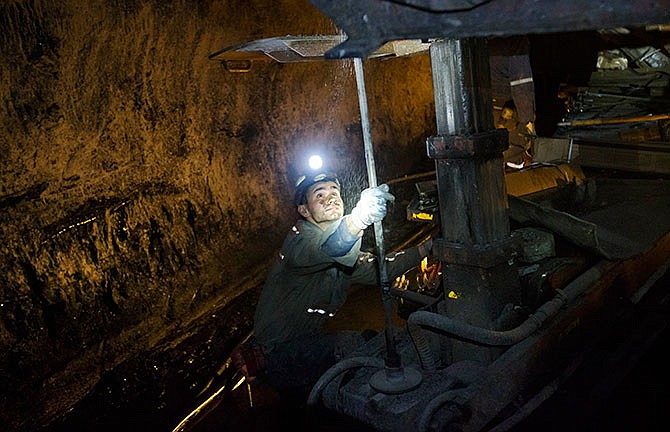 In this Oct. 6, 2015 photo, a miner works underground in the Sewell "R" coal mine in Yukon, W.Va. For the long-suffering communities that depend on coal, a recent Supreme Court ruling temporarily blocking greenhouse gas reductions was seen as a rare victory. But coal country residents say the reprieve may only be temporary as utilities turn away from coal generation and production continues to slide. 