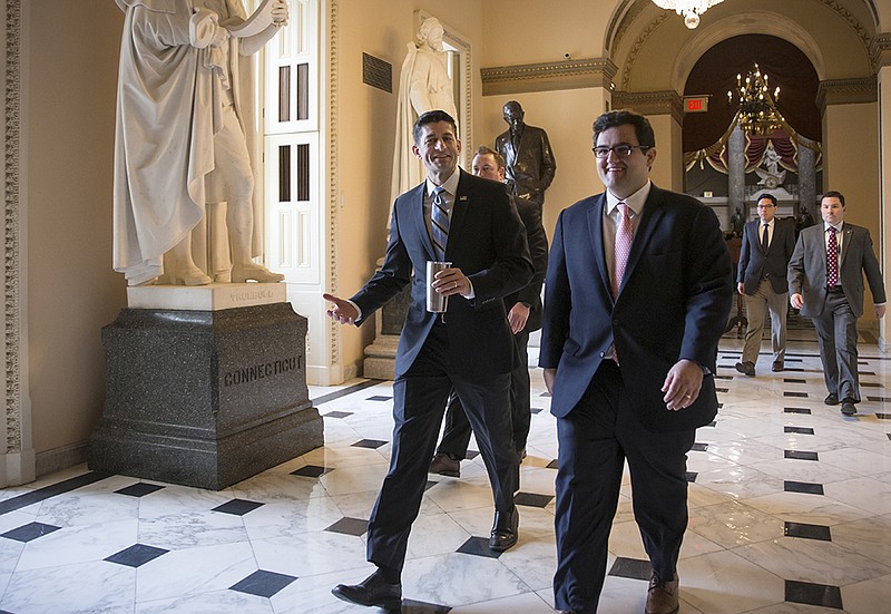 House Speaker Paul Ryan, center, walks Friday, Feb. 12, 2016 to the House chamber on Capitol Hill. Washington's Republicans and Democrats joined together to overwhelmingly approve legislation that hits North Korea with more stringent sanctions. 