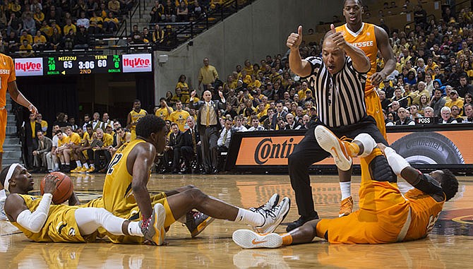 Referee Glenn Tuitt calls a jump ball as Missouri and Tennessee players lay on the court during the second half of an NCAA college basketball game, Saturday, Feb. 13, 2016, in Columbia, Mo. Missouri won the game 75-64.
