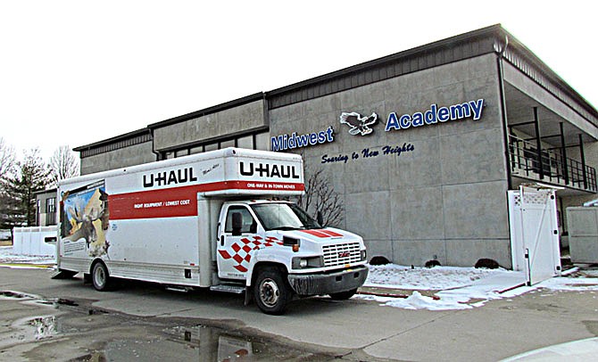 In this photo taken on Thursday, Feb. 11, 2016, a Uhaul is parked outside Midwest Academy in Keokuk, Iowa. Federal, state and county law enforcement officials have returned to the southeast Iowa boarding school for troubled teens following abuse allegations. The Keokuk Daily Gate reports officials with the FBI and the Iowa Division of Criminal Investigation returned to Midwest Academy on Thursday to execute a search warrant for records following an initial search of the academy on Jan. 28 and 29. (Cindy Iutzi/Daily Gate City via AP) 