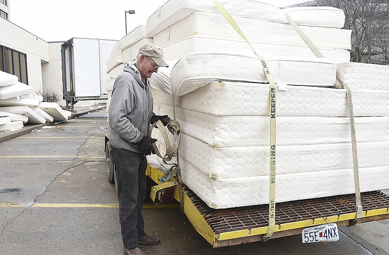 George Jennings with Pay It Forward Missouri, secures a load of mattresses donated by Capitol Plaza Hotel. Capitol Plaza is replacing bedding and donated 340 full- and king-size mattresses and box springs. Jennings will take them storage in Fulton where they'll be disseminated to victims of recent flooding or fires. The group, which works with the Red Cross, is based in Columbia and secures donations and to find those in need of clothing, furniture, bedding and other home items.