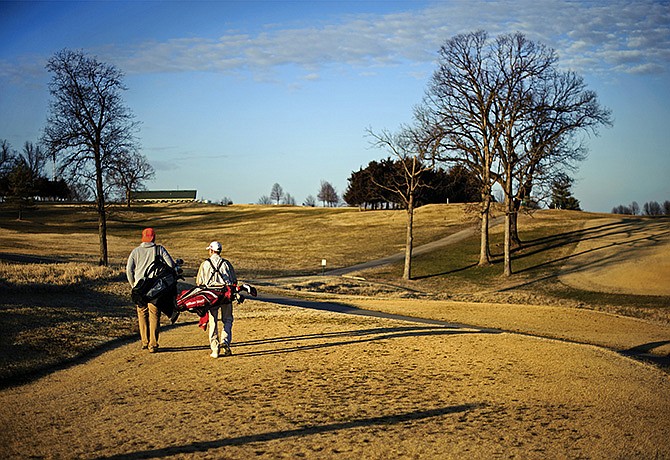 Caleb Albertson, left, and Nick Alexander exit the tee box and head toward the fairway after teeing off on hole seven while playing a round of golf at Oak Hills Golf Center on Wednesday afternoon. An Oak Hills committee and the Jefferson City Parks and Recreation Commission are discussing allowing the sale of alcohol at the course.