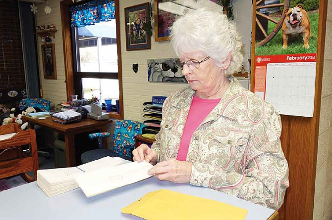 Office secretary Linda Mealy, at the South Callaway Middle School, prepares to send a letter written more than 20 years ago to the person who wrote it. The stack of letters from a 1993 English assignment were uncovered about six years ago and are now being returned to their proper owners.