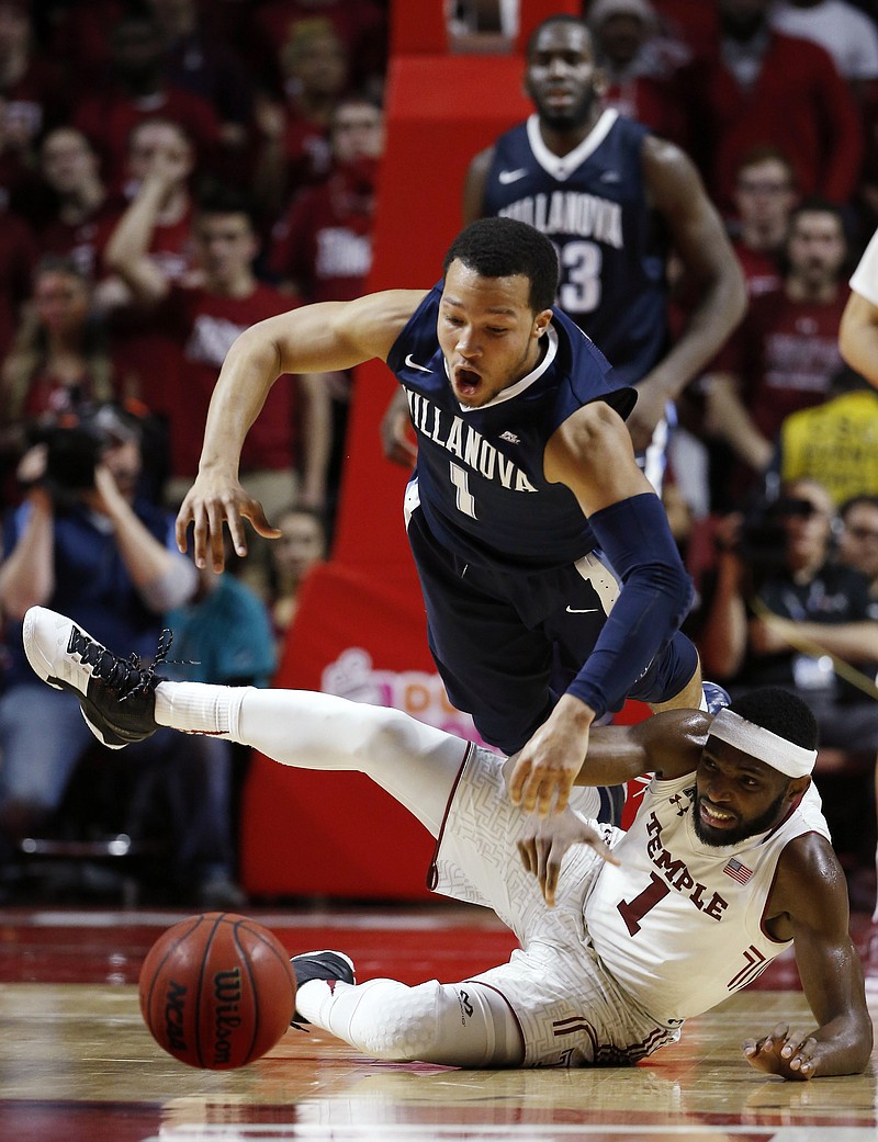 Villanova's Jalen Brunson, top, and Temple's Josh Brown collide while chasing the ball during the second half of an NCAA college basketball game Wednesday, Feb. 17, 2016, in Philadelphia. Villanova won 83-67. 