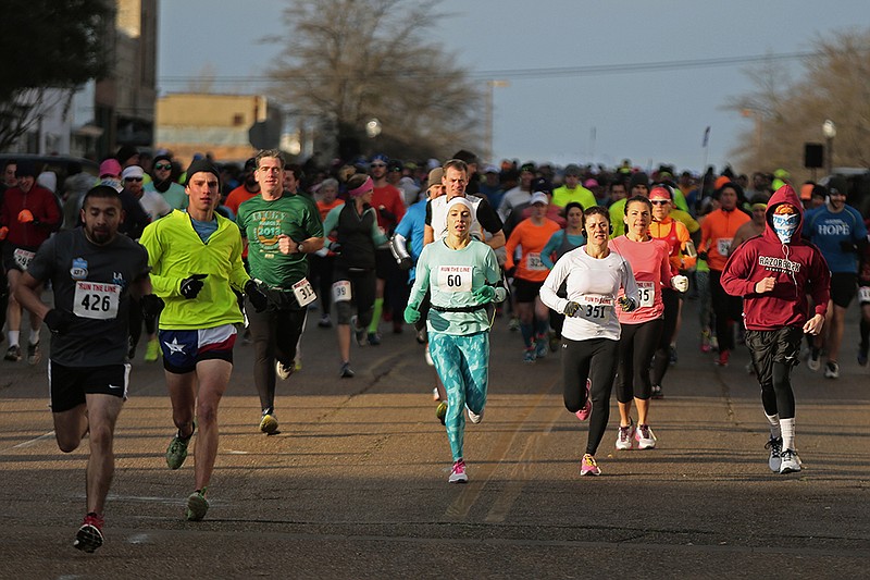 In this 2016 file photo, the starting line of the Run the Line half-marathon is crowded as hundreds of runners begin the 13.1-mile race through Texarkana. 