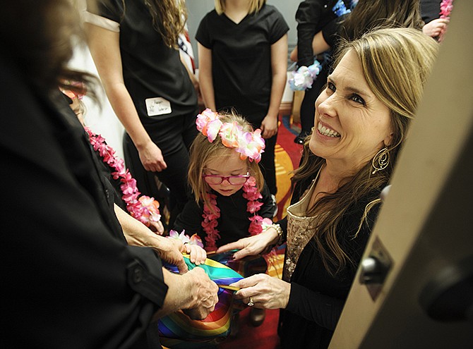In this Feb. 19, 2016 photo, Special Learning Center Foundation Director Heather Renkemeyer, right, smiles as she and other volunteers help the young members get dressed backstage for their next number during the evening's annual "Moments of Magic" fundraiser at the Doubletree Hotel. Proceeds raised from the event will help benefit the SLC.
