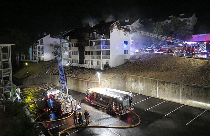 
Firefighters extinguish a fire that took the lives of four children Aug. 4, 2015 at an Osage Beach condominium unit. The building, part of the larger Compass Pointe Condomium Complex, was not equipped with smoke detectors because it was built in the 1980s before the district adopted fire codes.