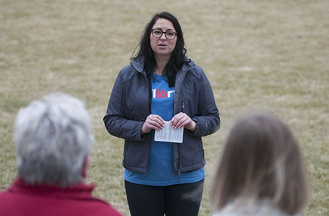 Katie Starkweather, a Hillary Clinton campaign volunteer, talks to rally participants on the Capitol lawn Tuesday.