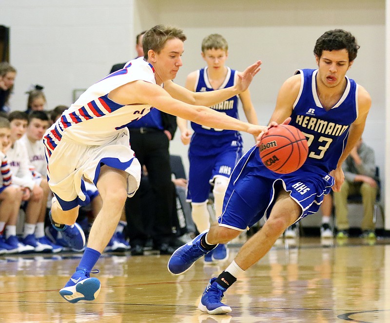 Wyatt Bestgen of California battles Trey McKague of Hermann for a loose ball in Tuesday night's Class 3 District 8 Tournament first-round game at Ashland.