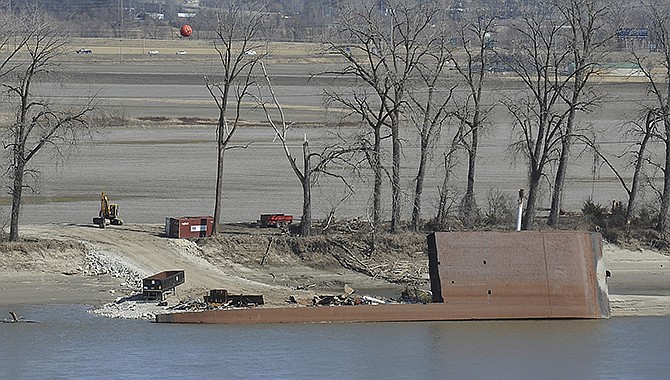 A crew has been busy disassembling the overturned sand dredge owned by Capital Sand Plant. It has been several months since the dredge took on water and listed in late July of 2015.