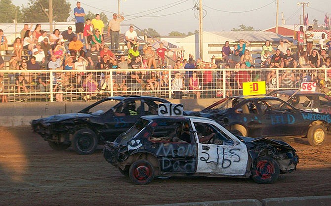 Fans at the Kingdom of Callaway County Fair cheer their favorite drivers during last year's Demolition
Derby.