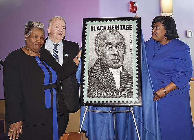 From left, Rev. Darlene Singe Smith, Postmaster Jason Hirschvogel and Rev. Cassandra Gould, pastor of Quinn Chapel A.M.E. Church, unveil the Richard Allen stamp during a ceremony Friday at Quinn Chapel. 