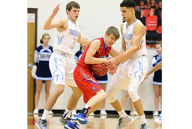 Father Tolton teammates Mason Schlotzhauer (left) and Michael Porter Jr. sandwich Wyatt Bestgen of California in Thursday night's Class 3 District 8 Tournament semifinal game at Ashland.