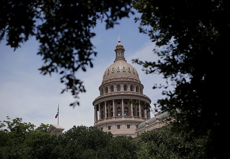 The dome of the Texas State Capital is seen through trees on the final day a special session, Tuesday, July 30, 2013, in Austin, Texas. 