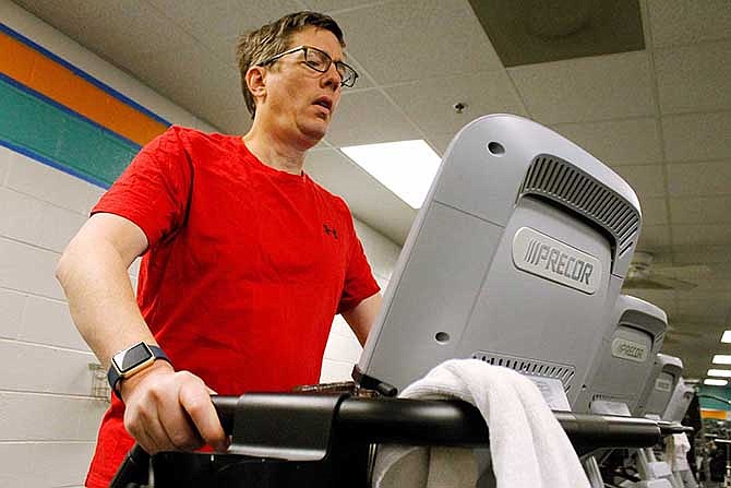 Mark Holloway, of Clemmons, North Carolina, goes through part of his exercise routine Tuesday at the Jerry Long YMCA in Clemmons. Holloway got a $350 Apple Watch for $25 by meeting exercise goals for two years. The program was offered through three U.S. companies.