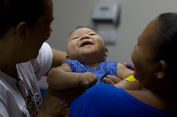 In this Feb. 25, 2016 file photo, Caio Julio Vasconcelos who was born with microcephaly undergoes physical therapy at the Institute for the Blind in Joao Pessoa, Brazil. Researchers say the Zika virus may be linked to a wider variety of "grave outcomes" for developing babies than previously reported and that threats can come at any stage of pregnancy.