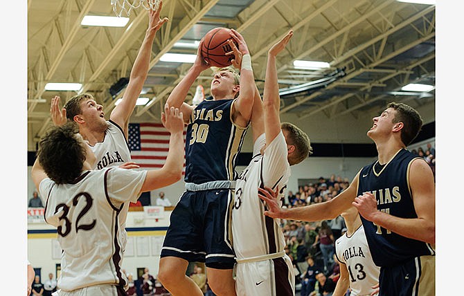 Helias forward Nathan Bax puts a shot up in heavy traffic during Saturday night's game against Rolla at Rackers Fieldhouse in Jefferson City.