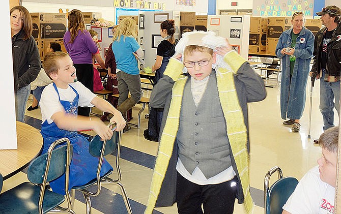 Fourth-grade students at South Callaway Elementary break down their displays after their "Living Biographies" event Feb. 26. During the event students dressed up as their history heroes and talked about some of the things their role models accomplished during their lifetime.            