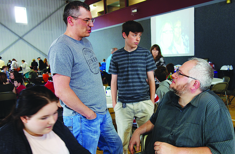 At right, Scott Yearton chats with brother Shawn and his son, Caige 14, during Solid Rock Family Church's fundraiser Sunday for the Yearton family. Scott's wife, Stacie, is battling a rare form of brain cancer. Pictured at left is 14-year-old Marley, one of Scott and Stacie Yearton's five children.