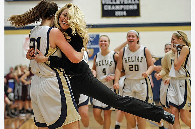 Mai Nienhueser of Helias swings head coach Sarah Eagan around the floor Saturday as the Lady Crusaders celebrate a 45-42 victory against the School of the Osage Lady Indians at Rackers Fieldhouse in Jefferson City.