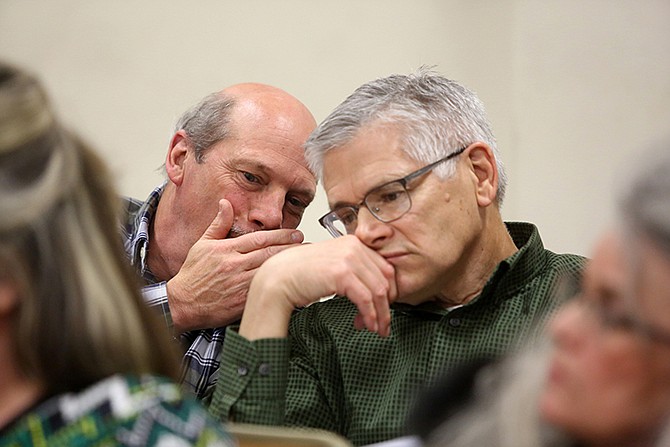 Rick Mihalevich, left, speaks to John Lyskowski on Thursday at a Planning and Zoning Commission meeting discussing the Hayselton Drive development proposal.