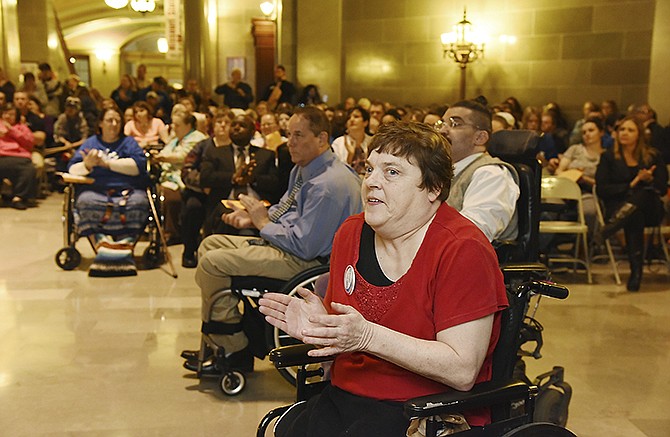 Becky Dickey applauds at comments made by a speaker Thursday at Disability Rights Legislative Day at the Capitol. Dickey, who is from Jefferson City, was there to help rally attendees visit with their legislators. 