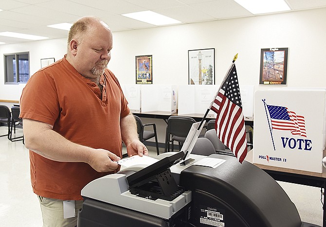 Kenny Hunt inserts his ballot into the electronic reader Tuesday, March 15, 2016 at the Association of Missouri Electric Cooperative on East McCarty Street, which serves as the polling place for Ward 1, Precinct 3.