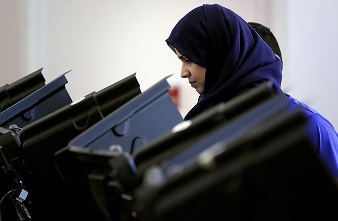 Nelofer Ahmed votes at the Mahatma Gandhi Cultural Center, Tuesday, March 15, 2016 in Ballwin. Voters in Missouri, as well as Illinois, Florida, Ohio and North Carolina are casting their ballots in primary elections Tuesday. (Huy Mach/St. Louis Post-Dispatch via AP)