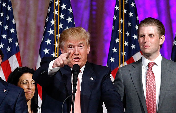 Republican presidential candidate Donald Trump speaks to supporters at his primary election night event at his Mar-a-Lago Club in Palm Beach, Fla., Tuesday, March 15, 2016. at right is his son Eric Trump.