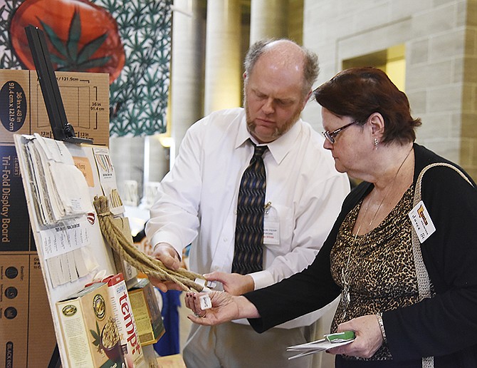 Steven Wilson, with Missouri Hemp Network, shows Joyce Slover items made from hemp Wednesday, March 16, 2016, in the state Capitol Rotunda.
