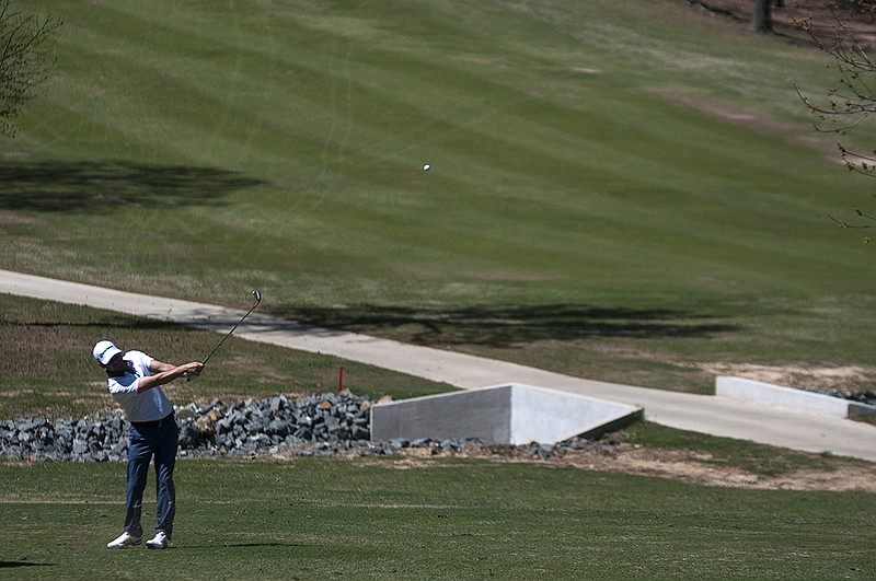 David Holmes takes his second stroke Wednesday, Mar. 16, 2016 from the fairway of hole 17 in the 27-team Texarkana Chamber Classic Pro-Am tournament at Northridge Country Club. 