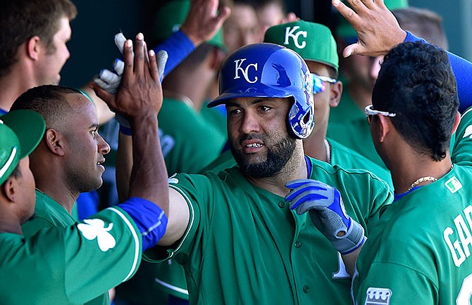 Kansas City Royals' Kendrys Morales is congratulated after hitting a two-run home run in the fifth inning against the Los Angeles Dodgers during a spring training baseball game Thursday, March 17, 2016, in Glendale, Ariz. (John Sleezer/The Kansas City Star via AP)