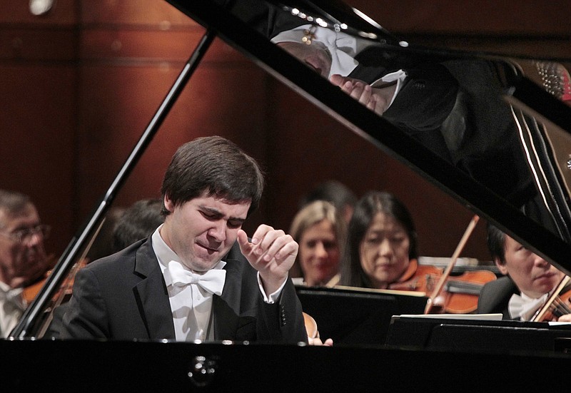 In this June 9, 2013 file photo, Vadym Kholodenko of Ukraine performs a concerto with the Fort Worth Symphony Orchestra during finals in the 14th Van Cliburn international piano competition in Fort Worth, Texas. Police say the two daughters of Kholodenko have been found slain in their Texas home and the musician's estranged wife is being treated for stab wounds. Benbrook police Cmdr. David Babcock said Friday, March 18, 2016 that Kholodenko is cooperating with investigators and that no one has been arrested in the deaths of 5-year-old Nika and 1-year-old Michela.