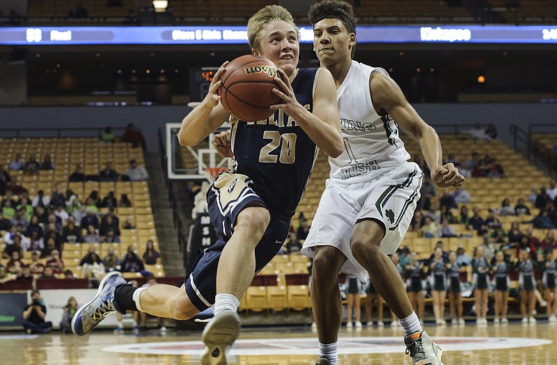 Landon Harrison of Helias drives past Lafayette's Diego Bernard during Friday night's game at Mizzou Arena.