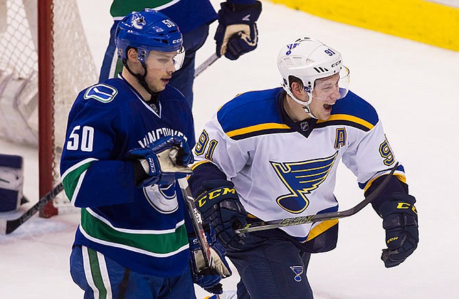 St. Louis Blues' Vladimir Tarasenko (91) celebrates his goal against the Vancouver Canucks as he skates past Canucks' Brendan Gaunce (50) during the third period of an NHL hockey game Saturday, March 19, 2016, in Vancouver, British Columbia. (Ben Nelms/The Canadian Press via AP)