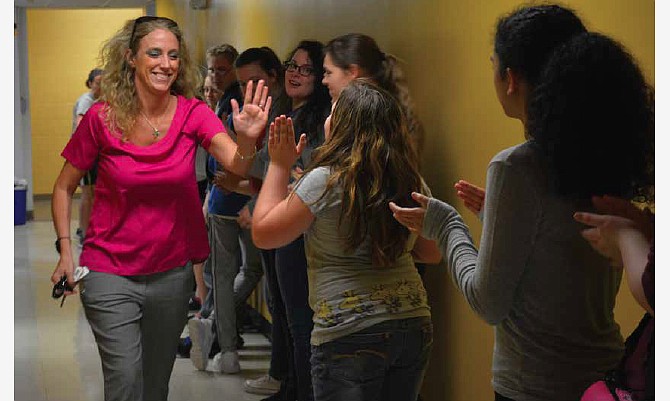 Fulton Middle School Principal Beth Houf receives high-fives from students who threw a party for her after she was named 2016 Missouri Distinguished Principal.