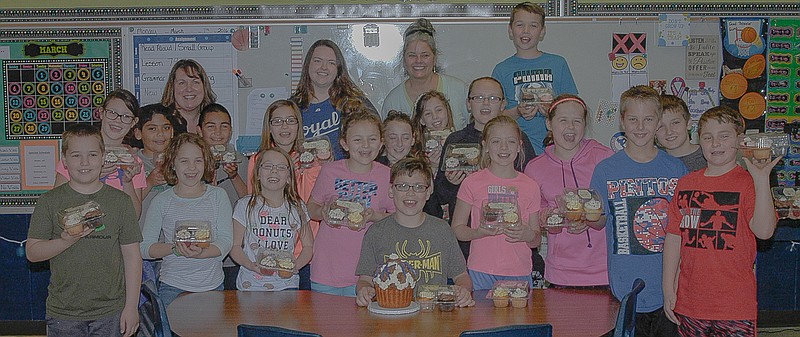 California fourth-grader Skip Figgins and his classmates enjoyed cupcakes provided by Baby Cakes Company, Kansas City, in response to the business appreciation letter the young man sent. Each class member received four cupcakes, and Figgins received the giant cupcake. Pictured in back, from left, are Baby Cakes employee Maggie Bradford and owner Laura Caron.