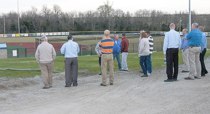 Checking out the area proposed for the baseball/softball restroom/concession stand to be constructed are the
administrators, teachers, board members and others in attendance at the California School Board meeting
March 16.
