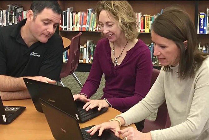 Mike Moon, California High School information technology director; Jamie Johnston, earth science teacher; and Janet Henley, librarian; review their 90-second video submitted to the Collaboration Nation contest, which could win the school $15,000 if their "Natural Disaster Research Video Project" receives the most Facebook votes daily April 1-15.
