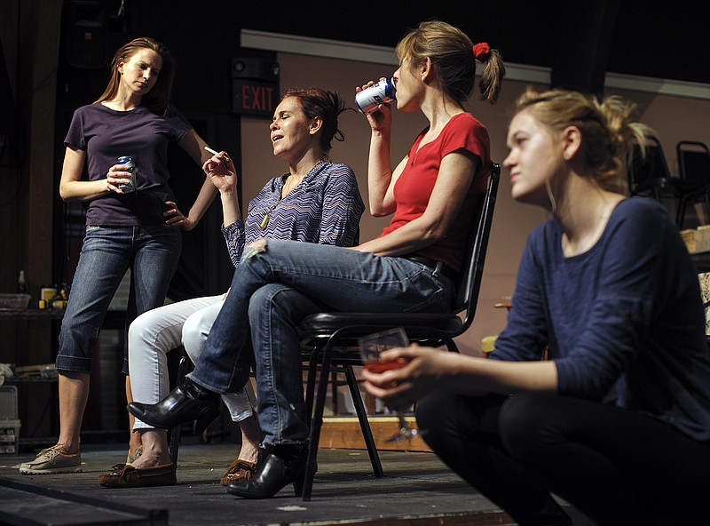 Violet, second from left, played by Kit Meyer, sits on the porch and tells stories to her daughters, from left, Barbara (Margaret Graham), Karen (Laura Morris) and Ivy (Jessi Green), during a rehearsal for Capital City Players' upcoming production of "August: Osage County" at Shikles Auditorium.