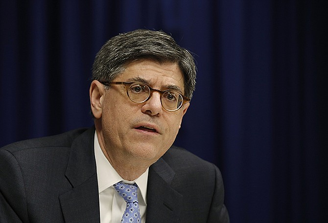 U.S. Treasury Secretary Jacob Lew speaks to journalists March 1 in Hong Kong. The Obama administration may soon tell governments and banks worldwide they can start using the dollar in to facilitate business with Iran.
